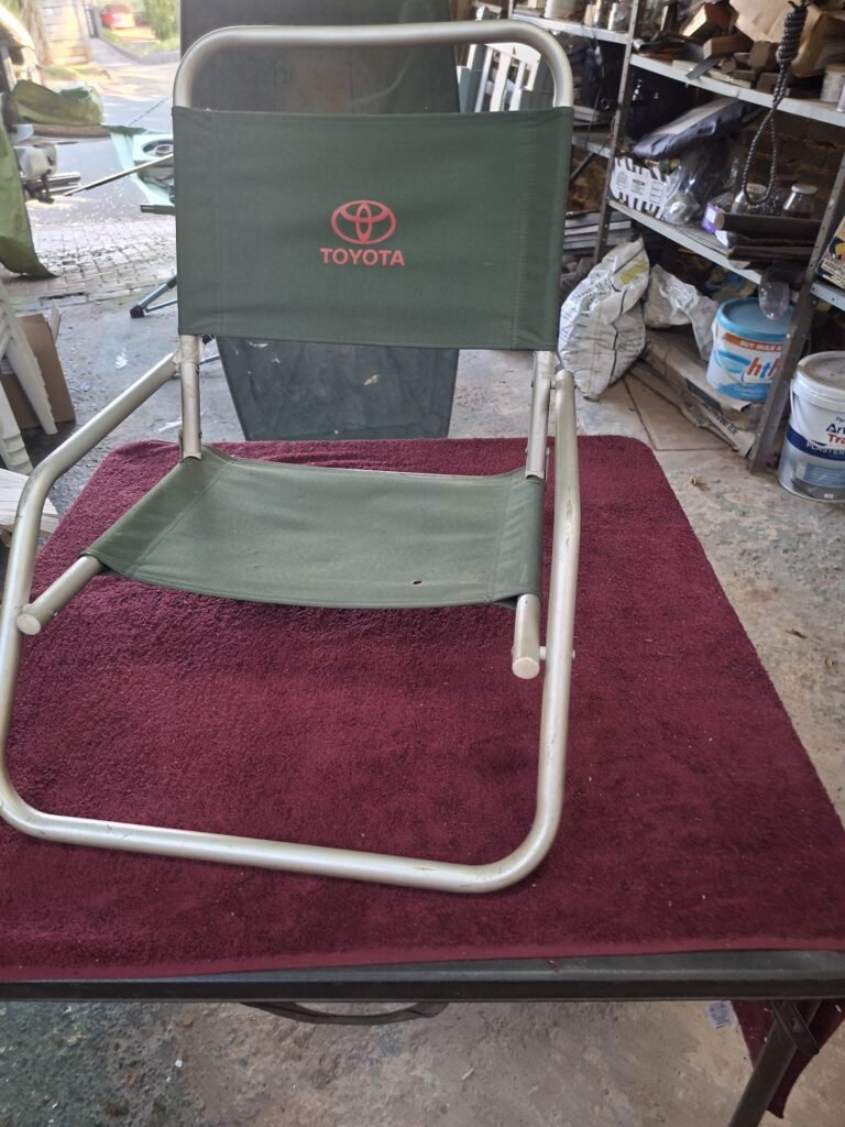 Used Folding Low Chair with Green Fabric and Toyota Logo
