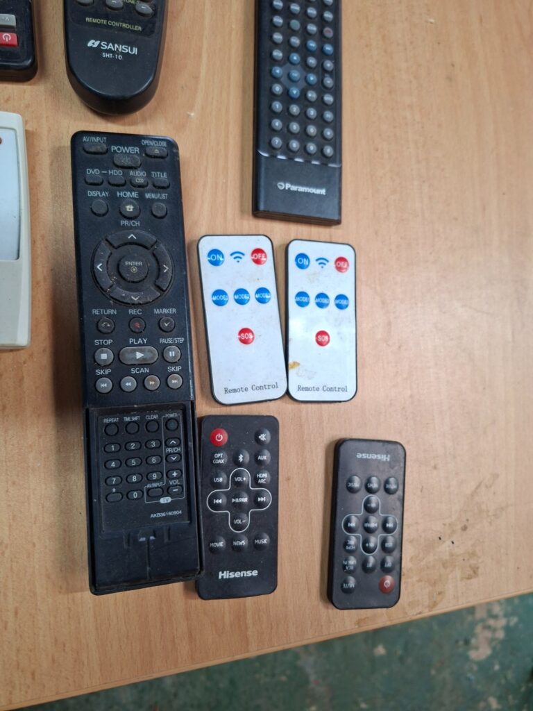 Lot: 8 assorted remote controls + Garmin GPS — used, untested, scratched Garmin screen