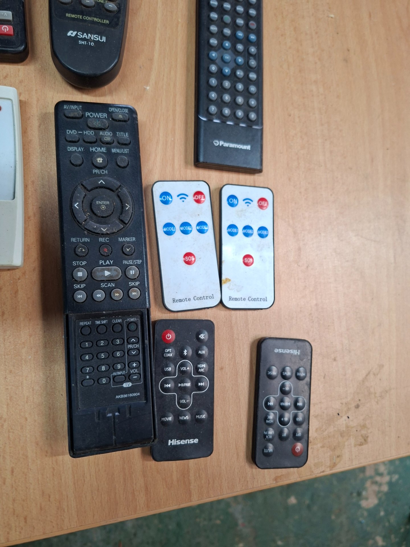 Lot: 8 assorted remote controls + Garmin GPS — used, untested, scratched Garmin screen