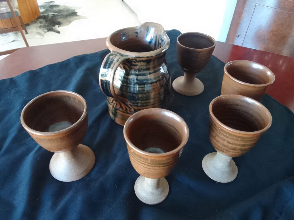 Six-piece glazed pottery set — pitcher with five goblet cups