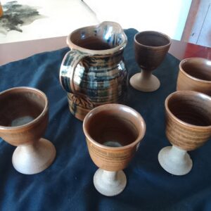 Six-piece glazed pottery set — pitcher with five goblet cups