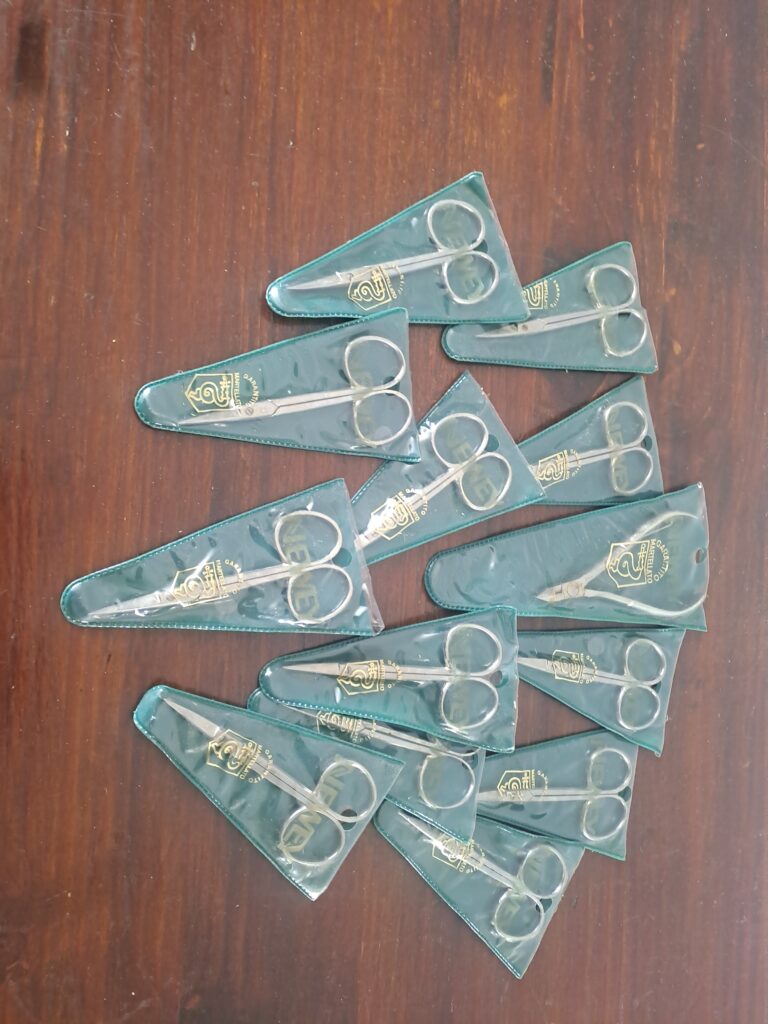 Set of approx. 12 Baby Cuticle Scissors in Green Triangular Sleeves