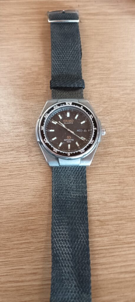 Seiko Quartz ‘Sports 100’ Wristwatch — Day/Date Dial, Woven Strap