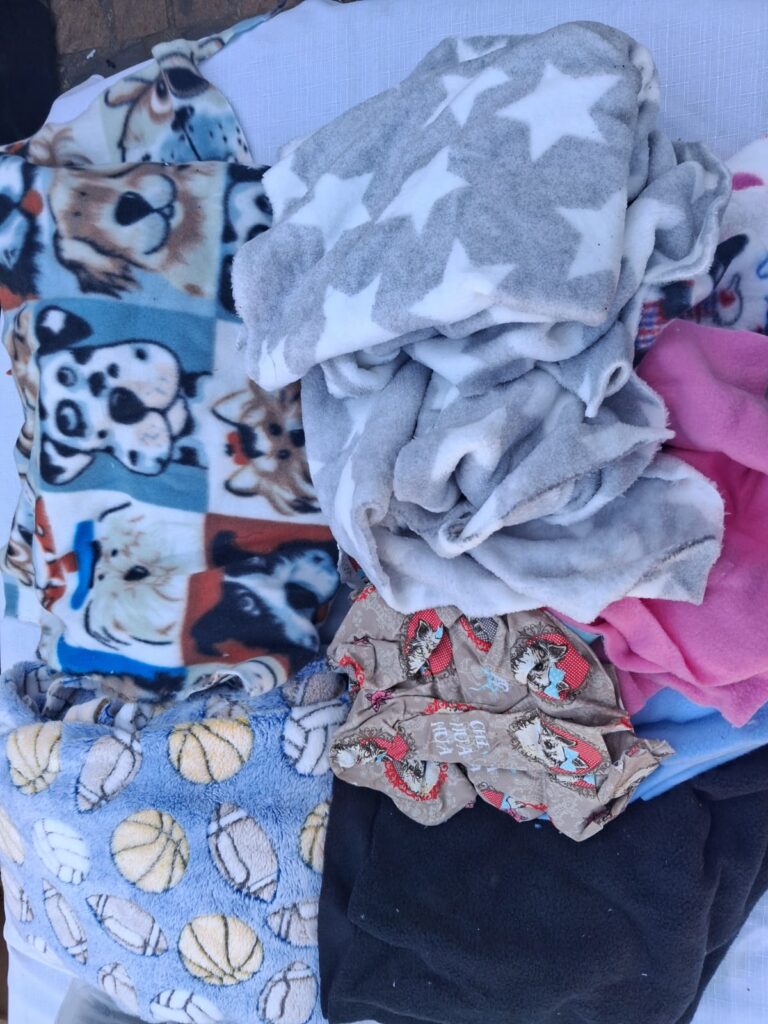 Lot of Assorted Used Fleece Blankets and Fabric Pieces