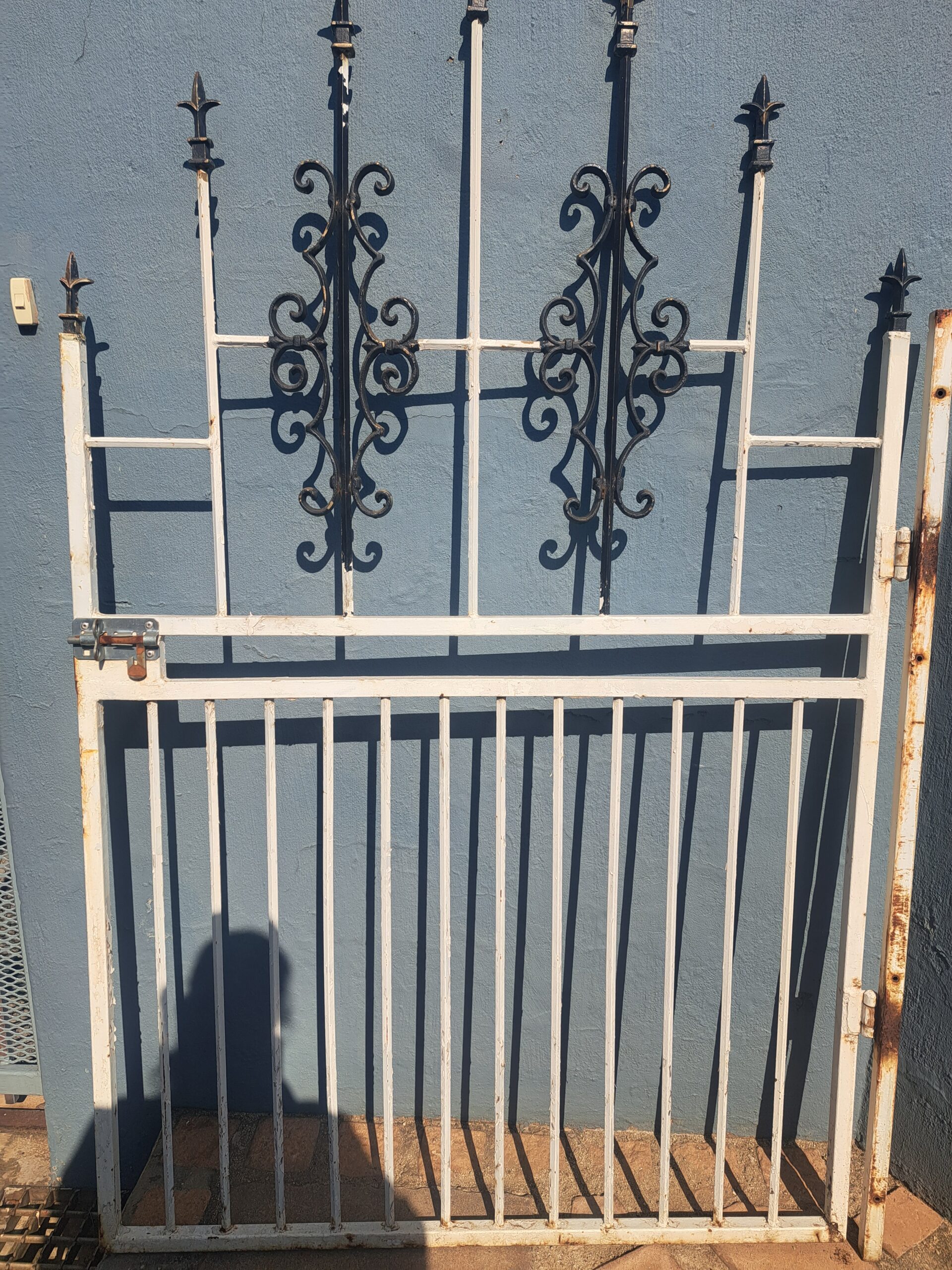Decorative Metal Security Panel / Gate with Scrollwork — White Frame, Rusted Areas