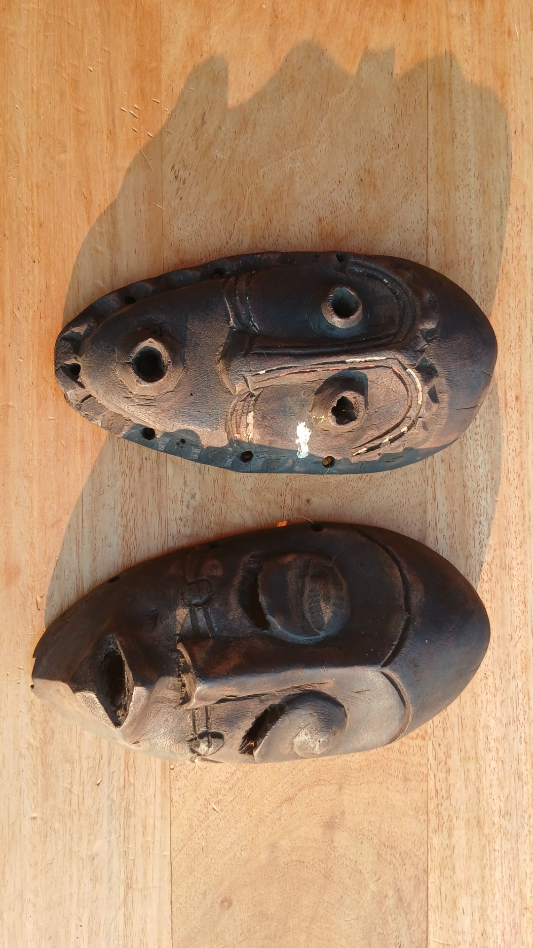 Pair of vintage carved wooden masks — small decorative masks, 25cm x 16cm each