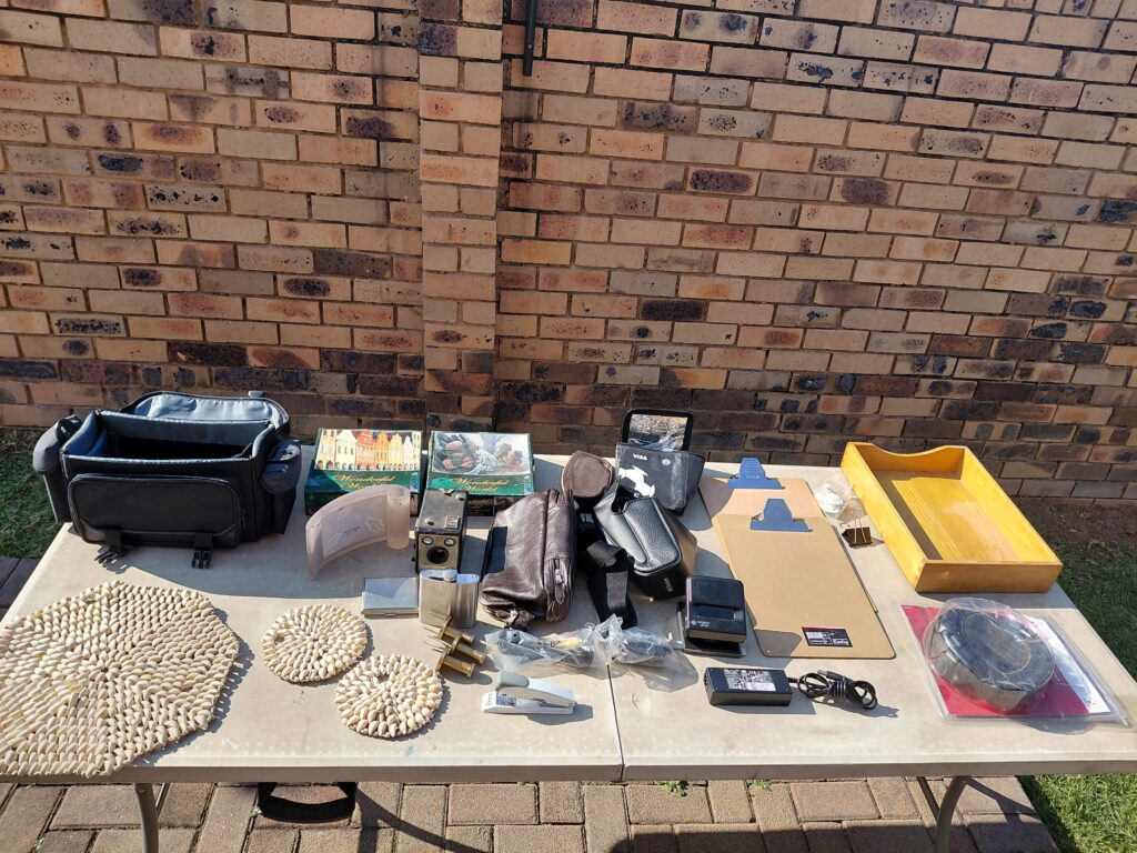 Table lot of mixed small household & camera items (approx. 20–30 pieces)