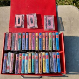Collection of StorieMuis Afrikaans cassette story tapes in red carrying case