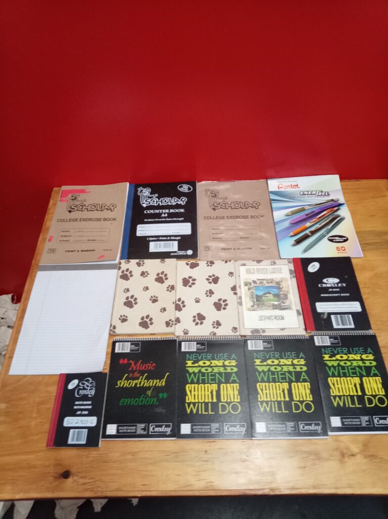 Mixed lot of exercise books & exam pads — ~14 paper notebooks/pads