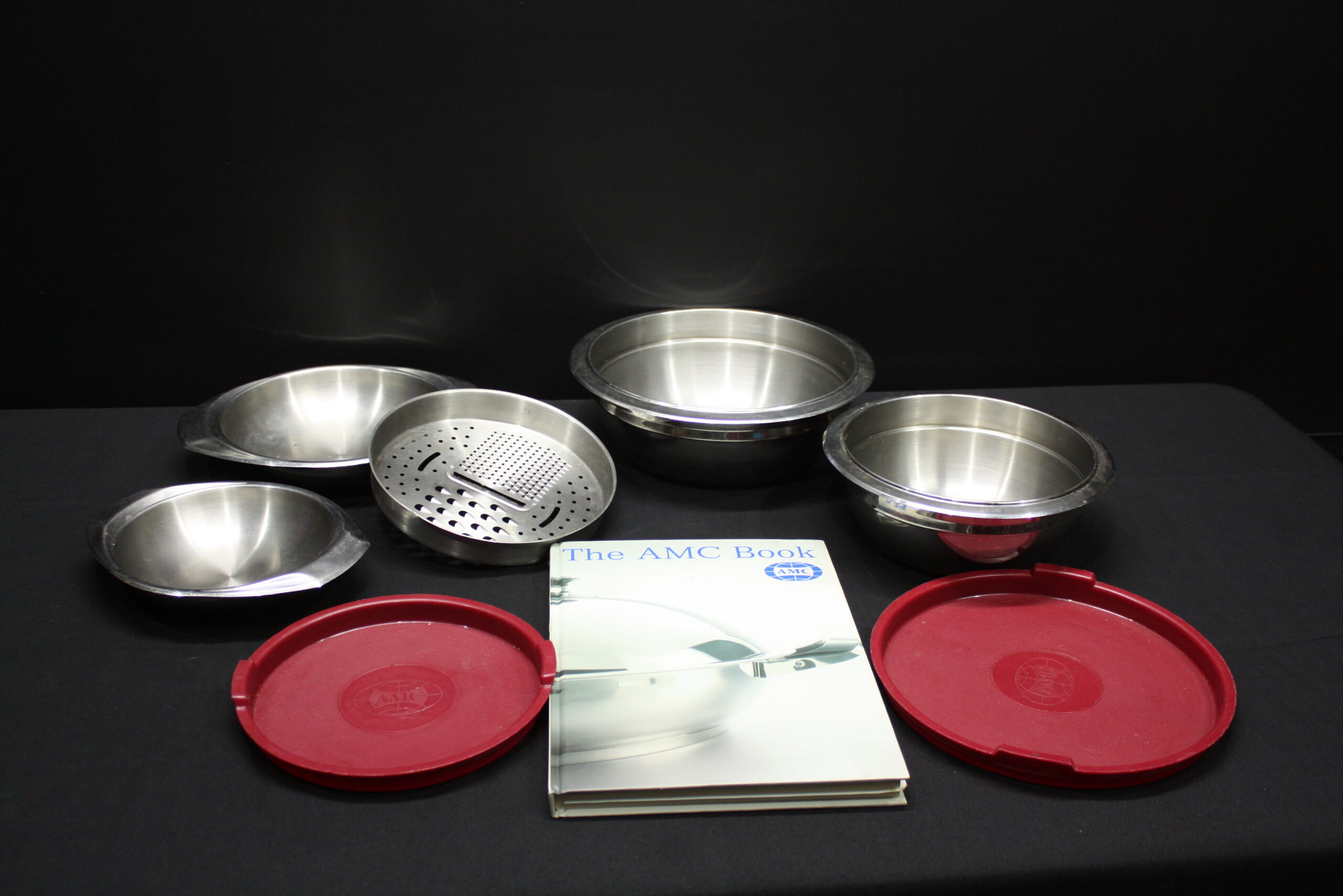 Set of A.M.C. steel kitchen bowls with grater, 2 red lids & AMC booklet (8 pcs)