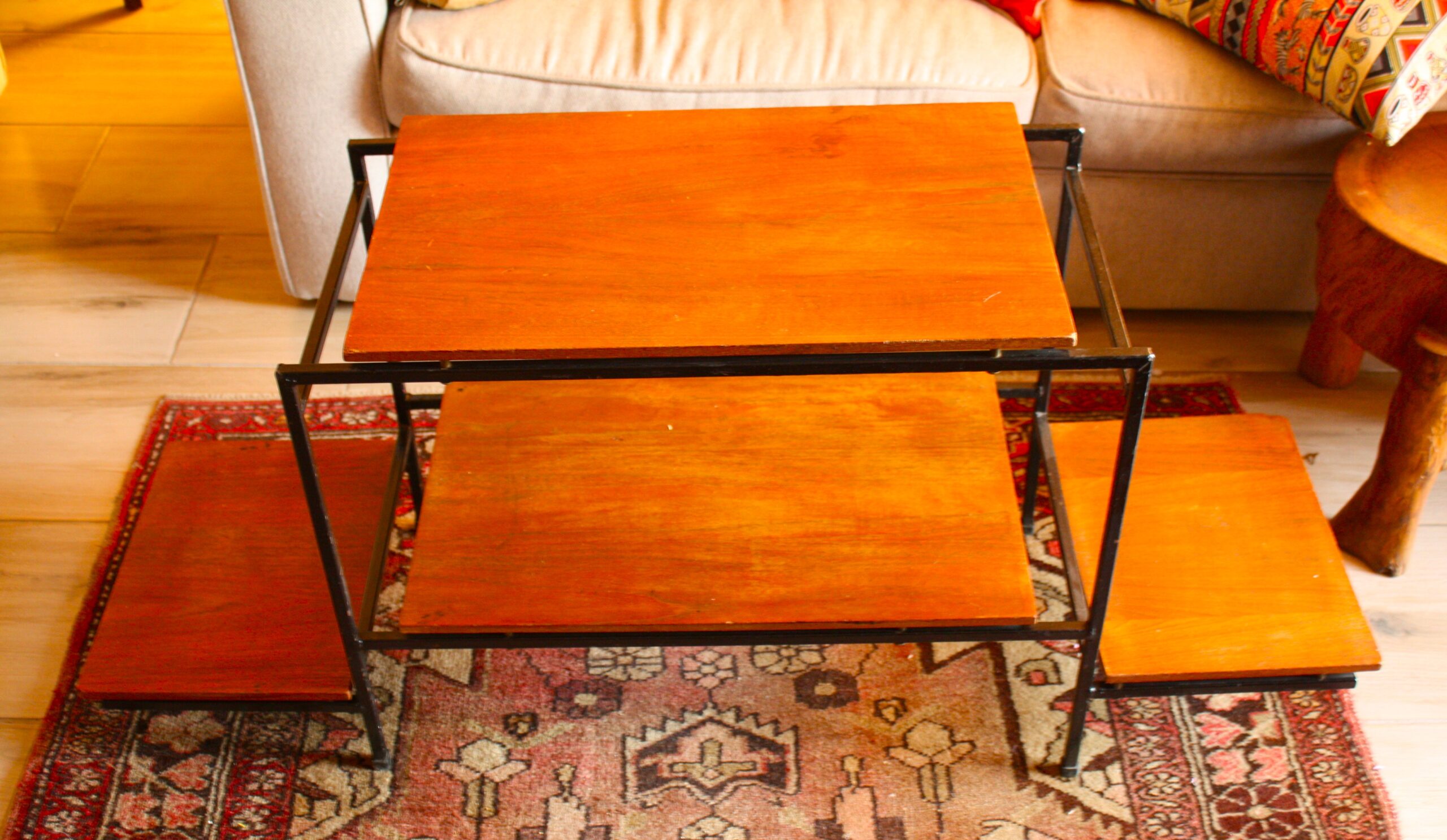 Wood-top TV stand with black metal frame — used, surface wear