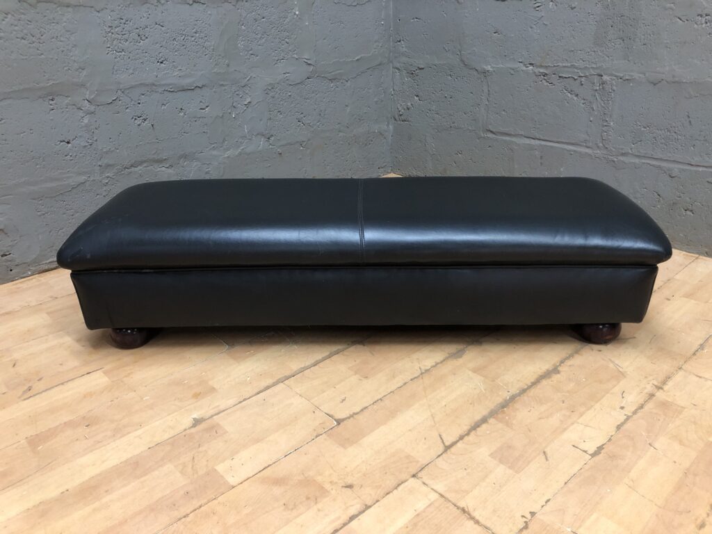 Black low rectangular upholstered ottoman / bench