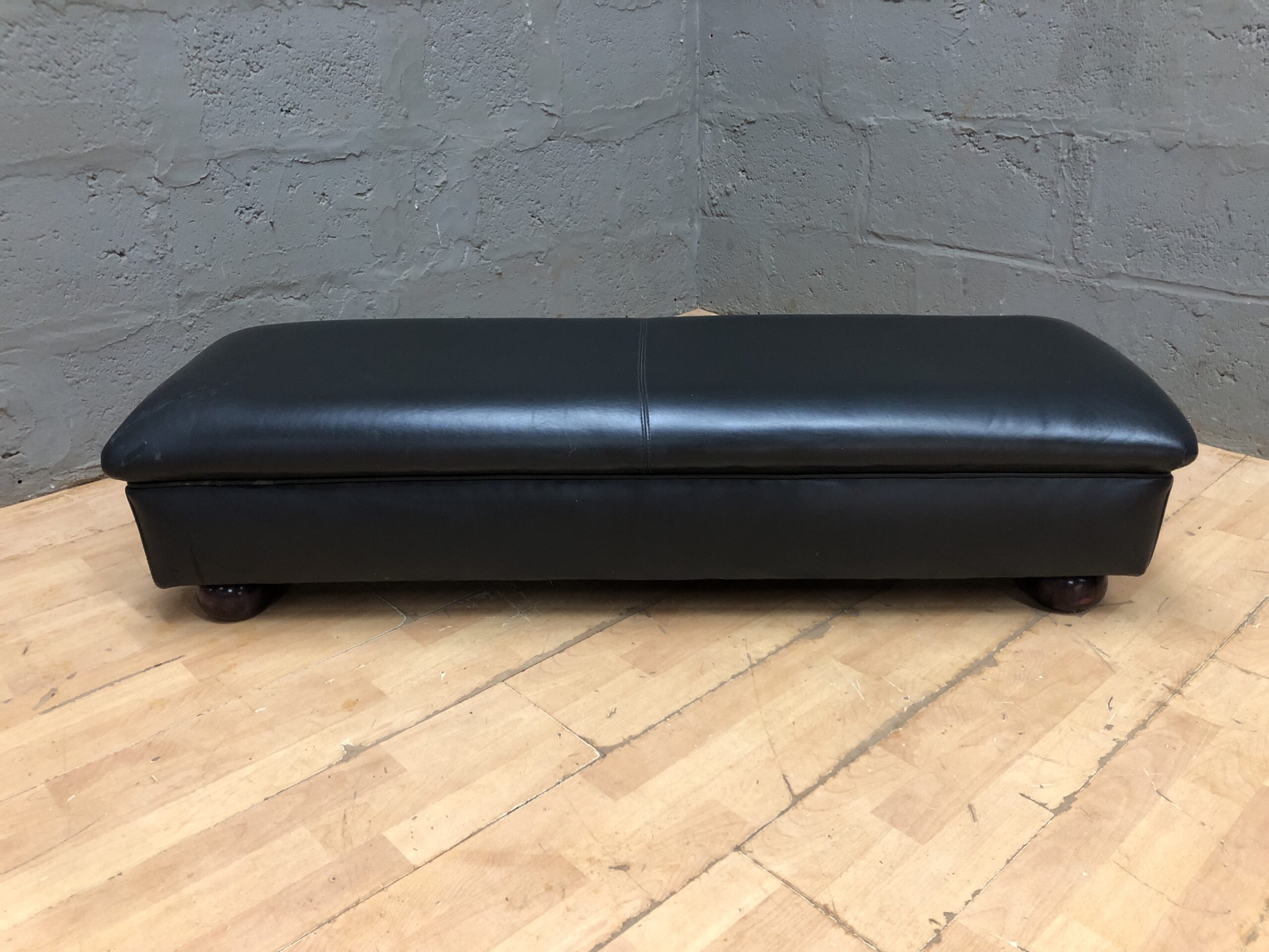 Black low rectangular upholstered ottoman / bench