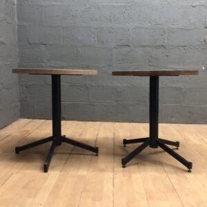 Pair of Small Round Pedestal Tables with Light Wood Tops and Black Bases