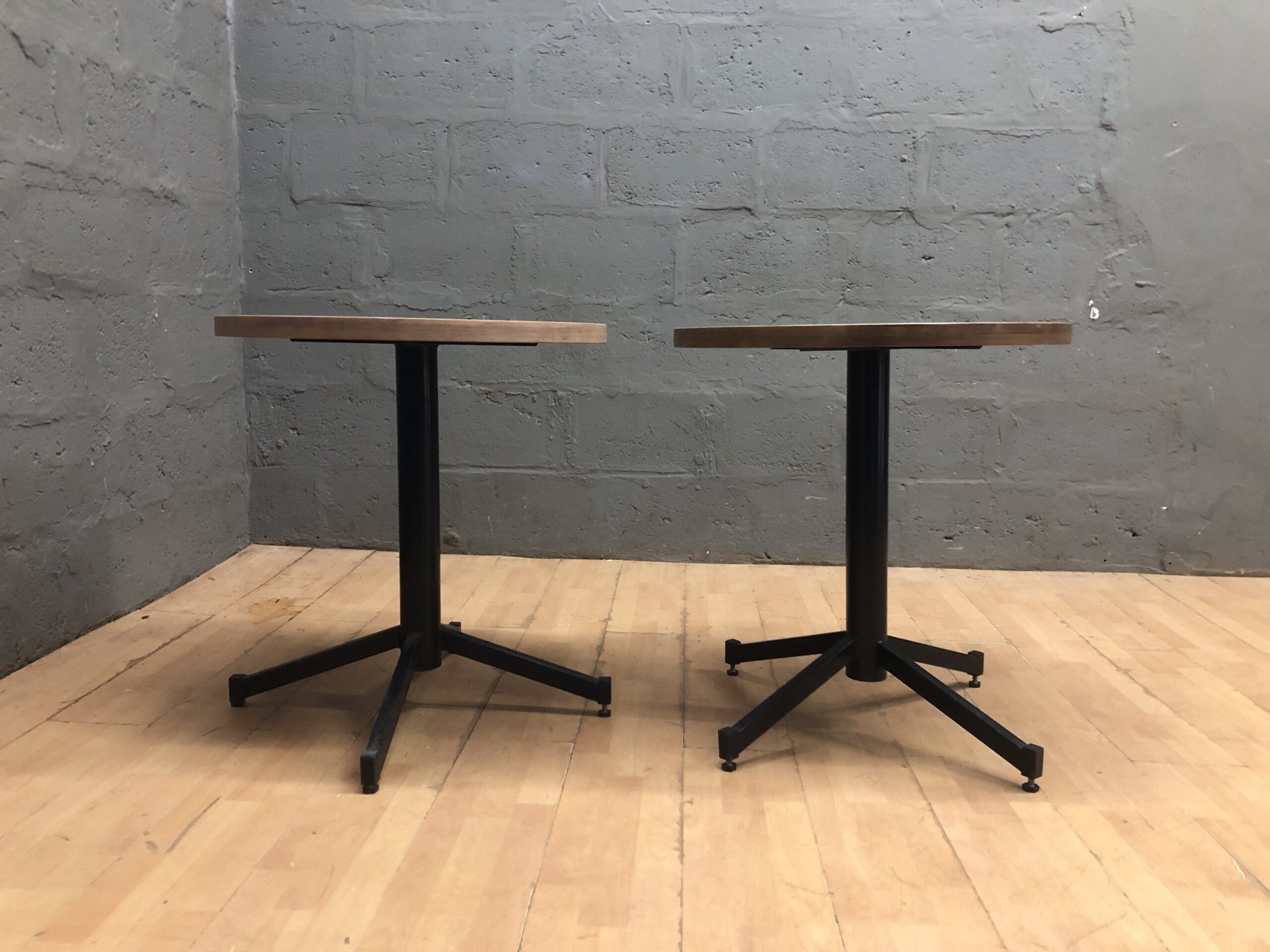Pair of Small Round Pedestal Tables with Light Wood Tops and Black Bases