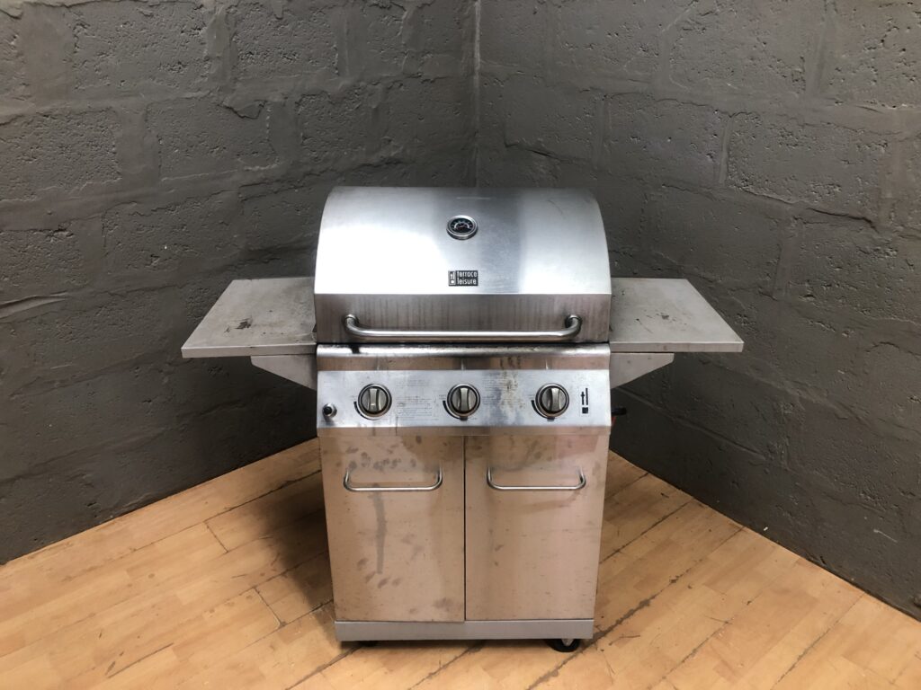 Three-burner freestanding gas barbecue / grill on wheeled cabinet, with side shelves
