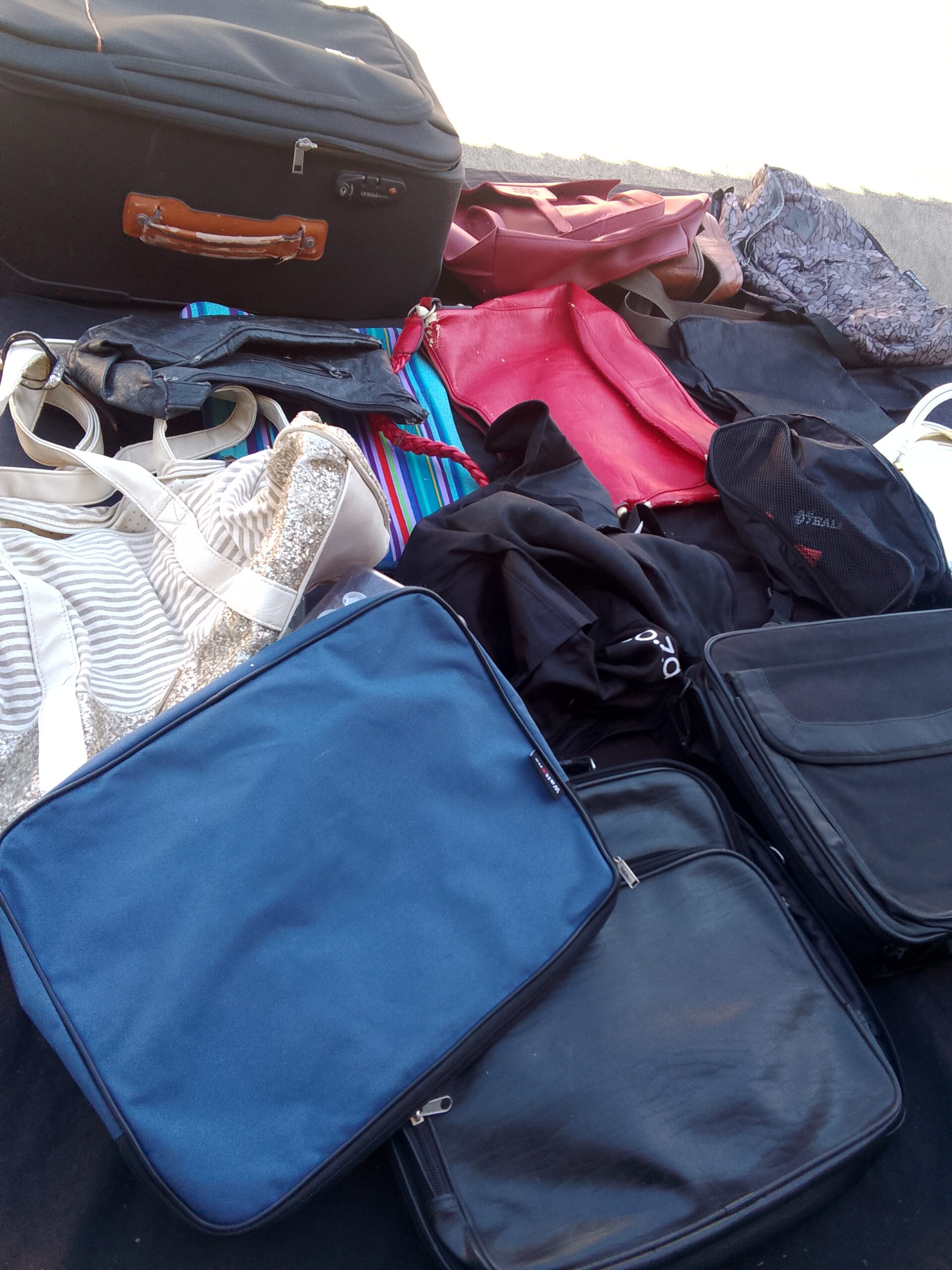 Lot of assorted bags and small suitcases – mixed colours, visible wear