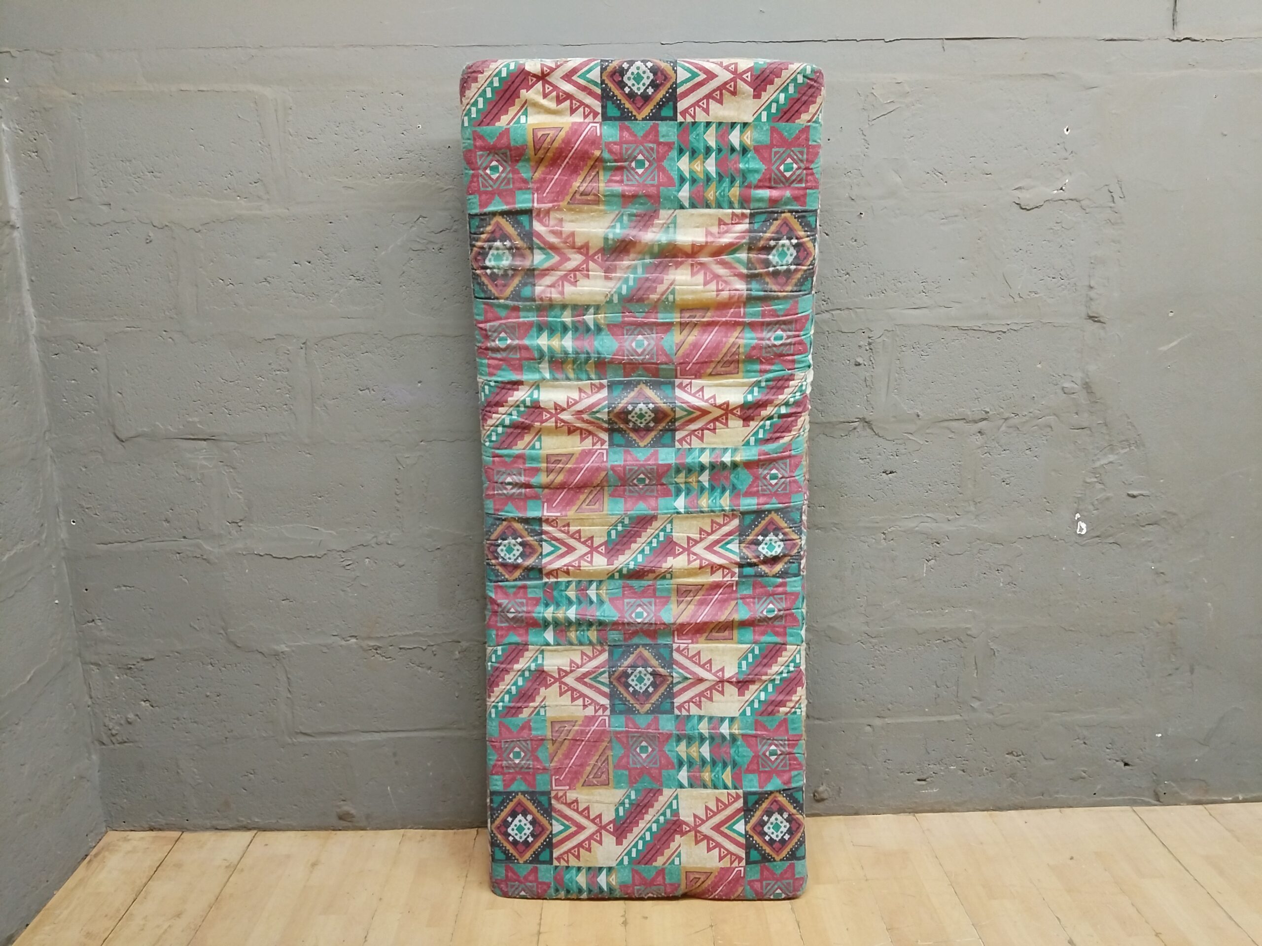 Used Single Mattress with Multicoloured Geometric Cover — 90 x 75 cm