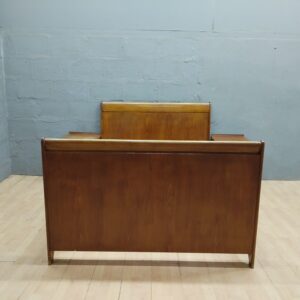 Double bed frame with two matching nightstands, wood-tone finish, visible surface wear