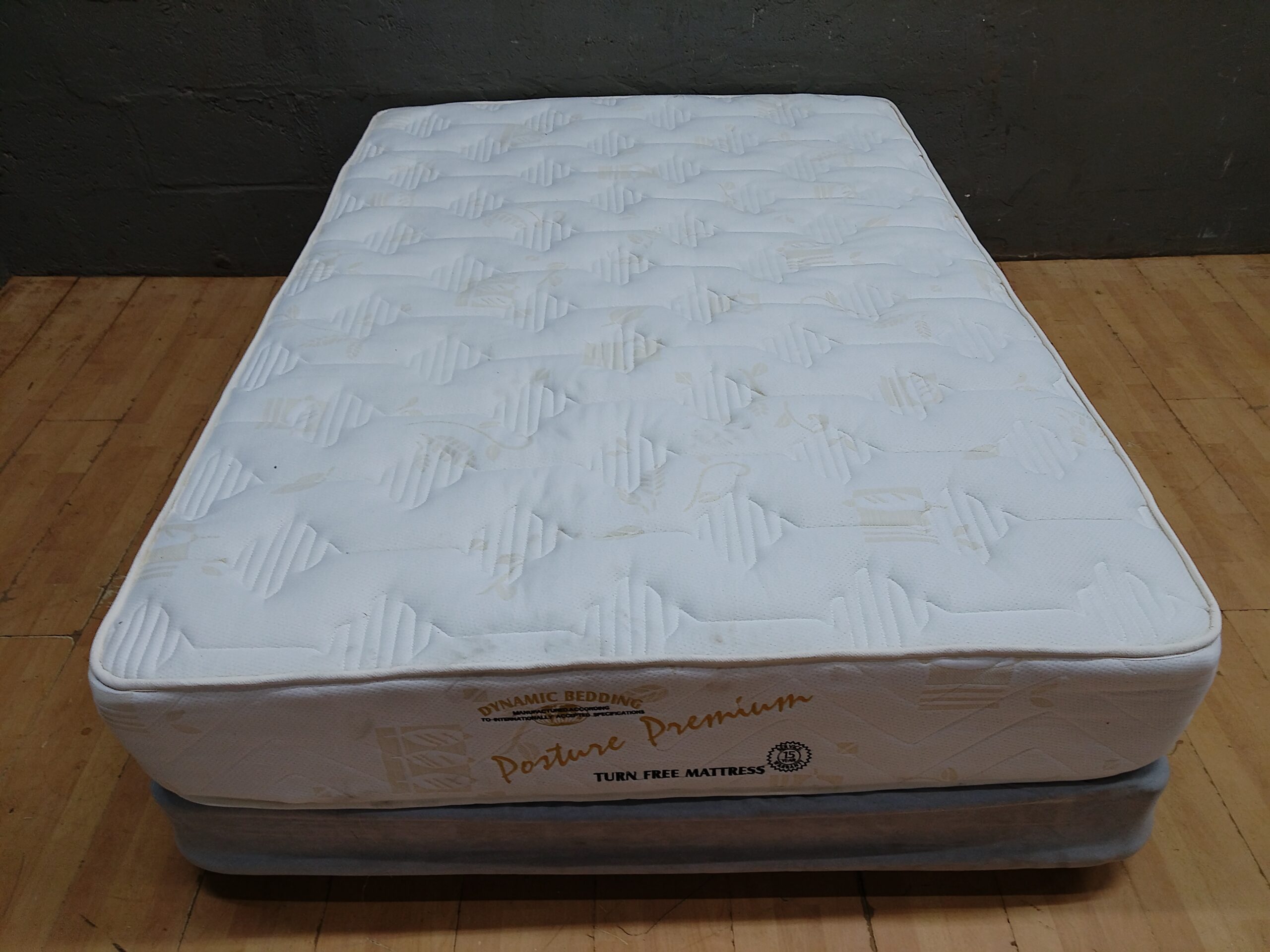 Dynamic Bedding Posture Premium double mattress on grey divan base (used, stained)