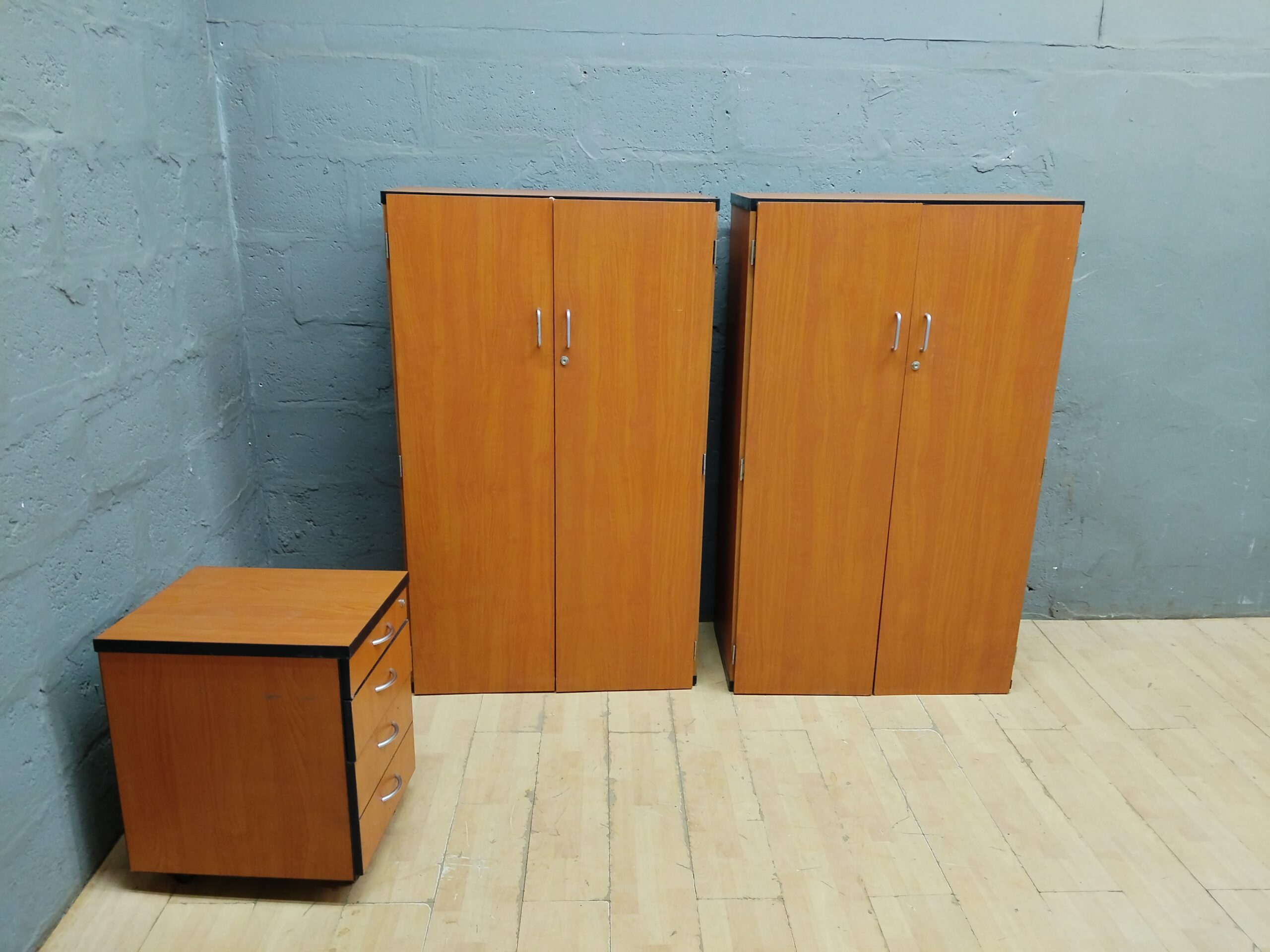 Wood-tone storage set: 2 tall cabinets + 4-drawer mobile pedestal (3 pieces)