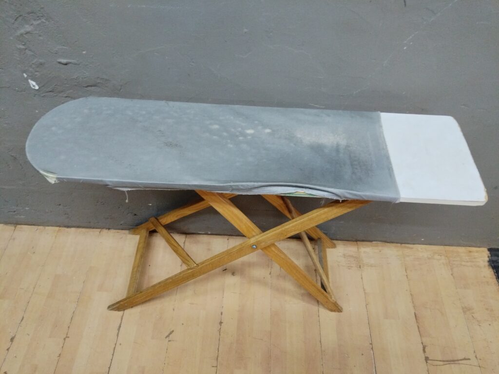 Used Folding Ironing Board with Wooden X-Frame Legs and Grey Cover