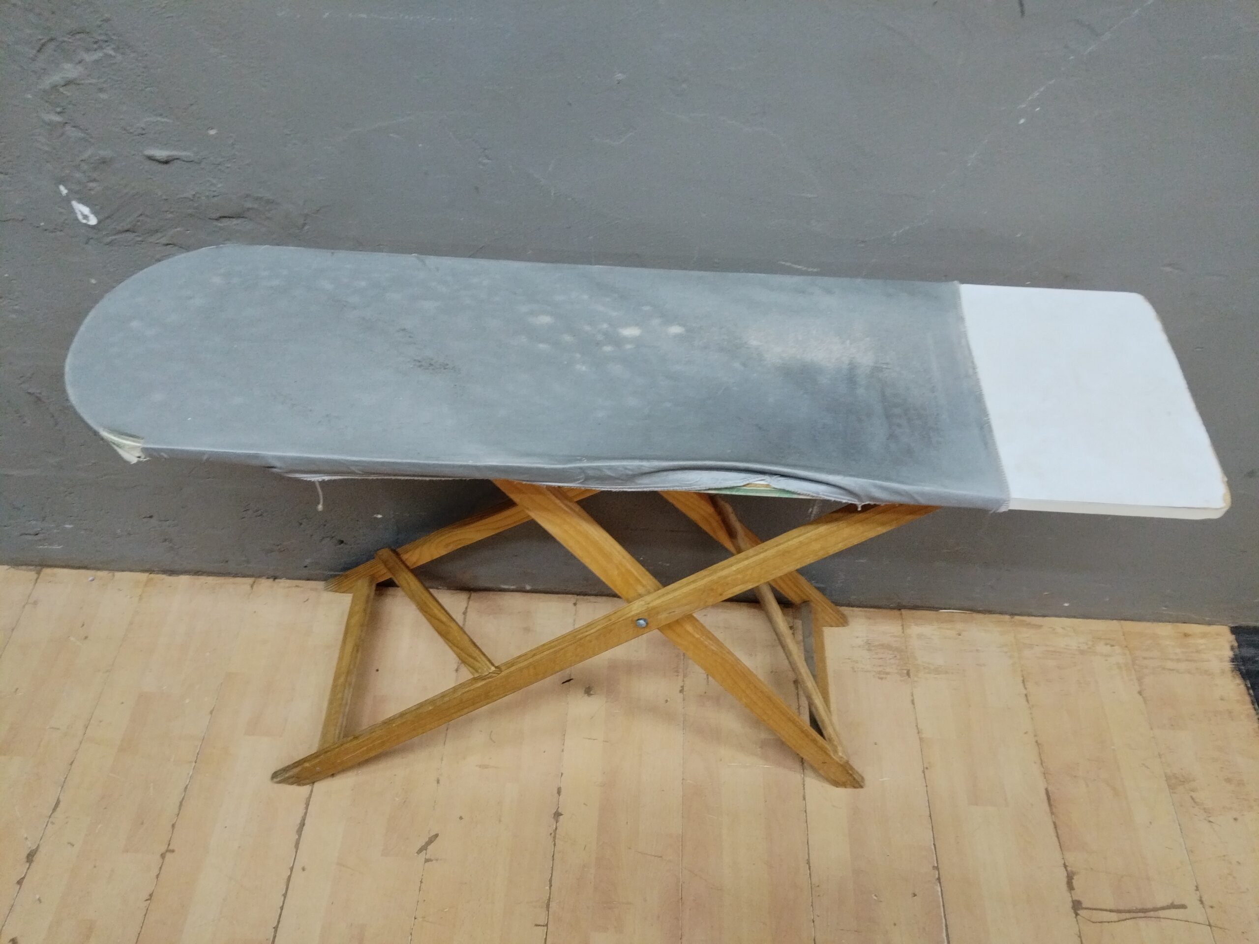 Used Folding Ironing Board with Wooden X-Frame Legs and Grey Cover