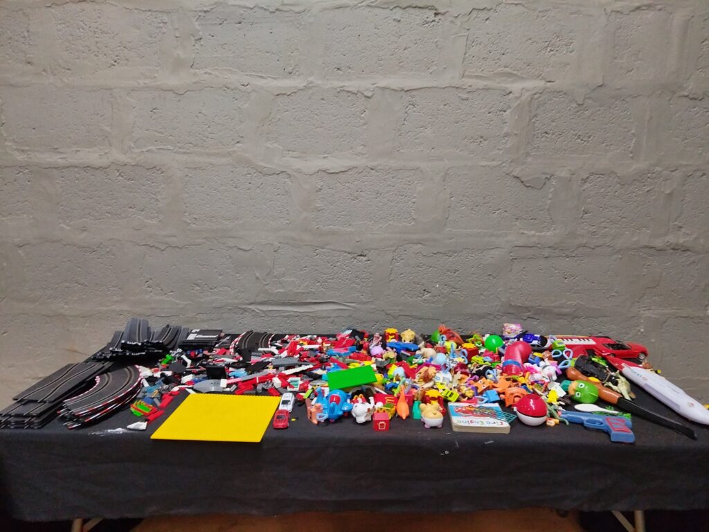 Mixed bulk lot of ~200 used small toys, figures, cars + partial Carrera slot-car track & control module (not working)