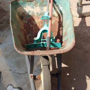 Rusty Single-Wheel Metal Wheelbarrow — Solid Frame, Tub with Surface Rust, Wheel Holds Air