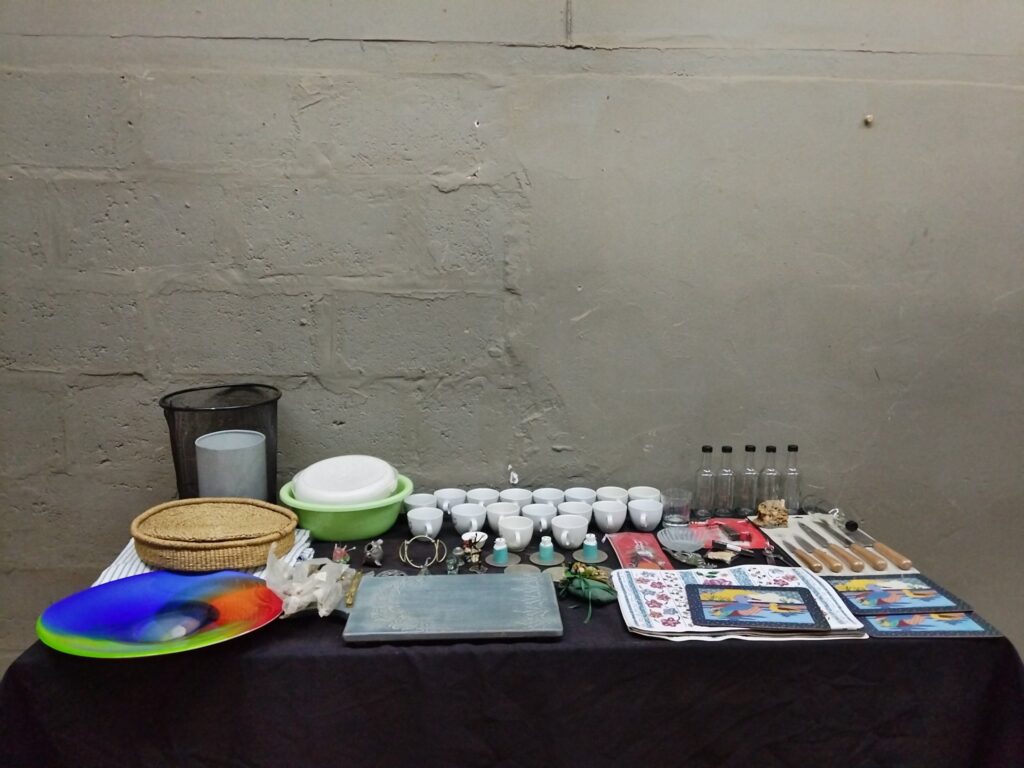 Bulk mixed household lot — cups, glass bottles, knives (57 items, used/mixed condition)
