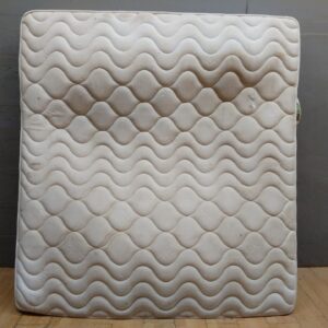 King-size pocketed coil mattress (labelled 'Pocketed Coil Collection') — heavily soiled, torn corner, salvage condition