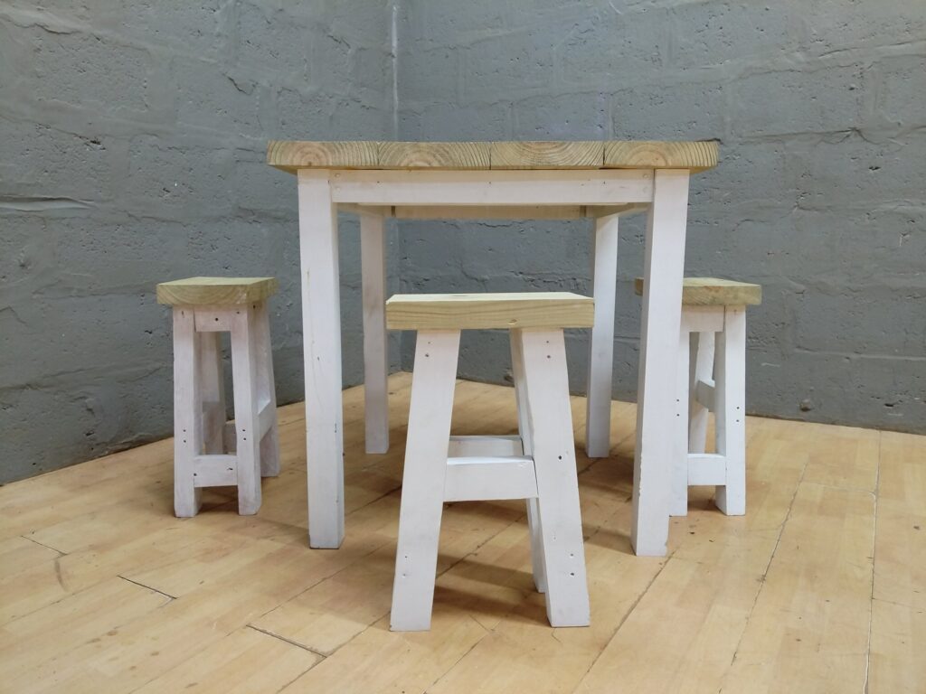 Square wooden table + 3 matching stools — painted legs, raw pine tops (5 pieces)