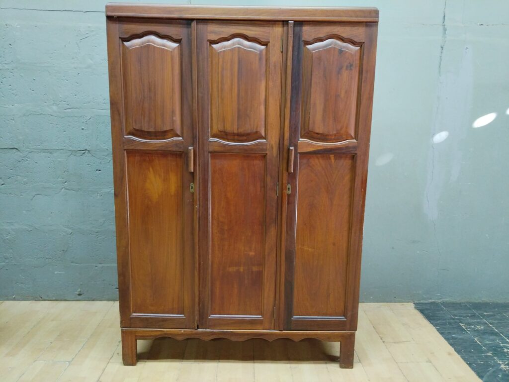 Three‑door wooden wardrobe / armoire with right-hand slide-out trays and hanging rail