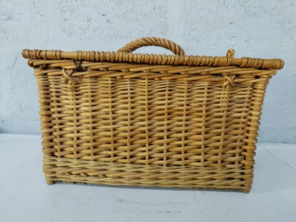 Woven wicker storage/picnic basket with hinged lid, twisted handle and small feet — fair condition