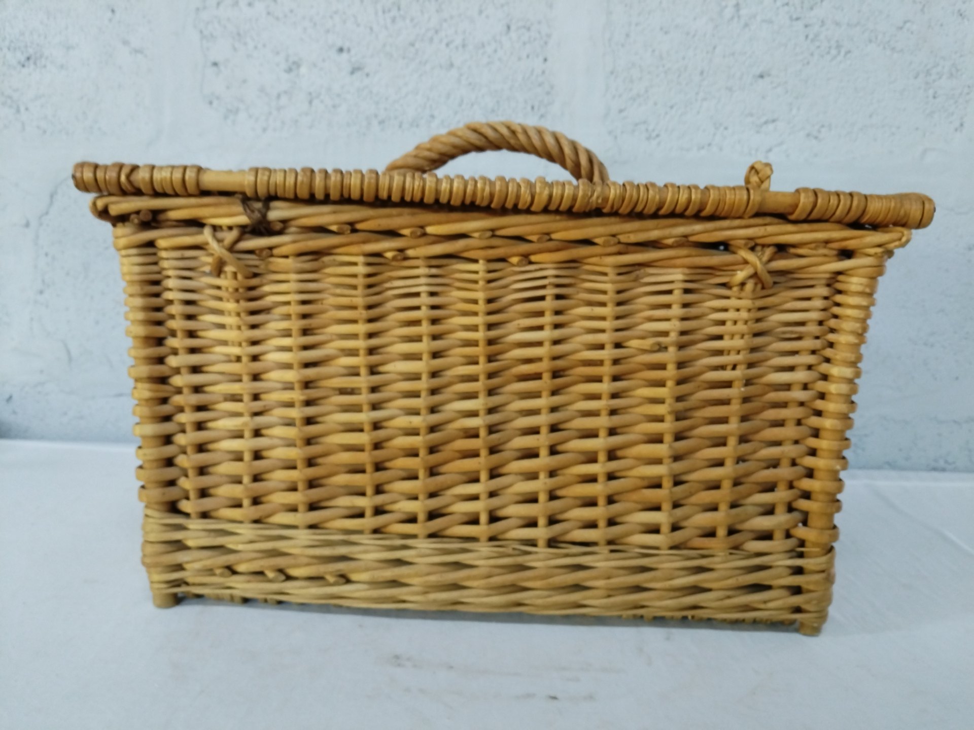 Woven wicker storage/picnic basket with hinged lid, twisted handle and small feet — fair condition
