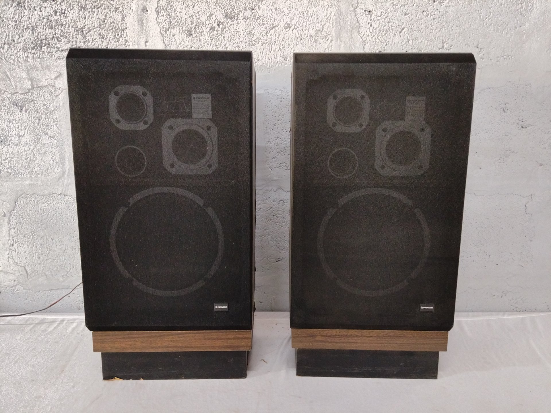 Pair of Pioneer floor‑standing speakers (badge visible) — used, untested