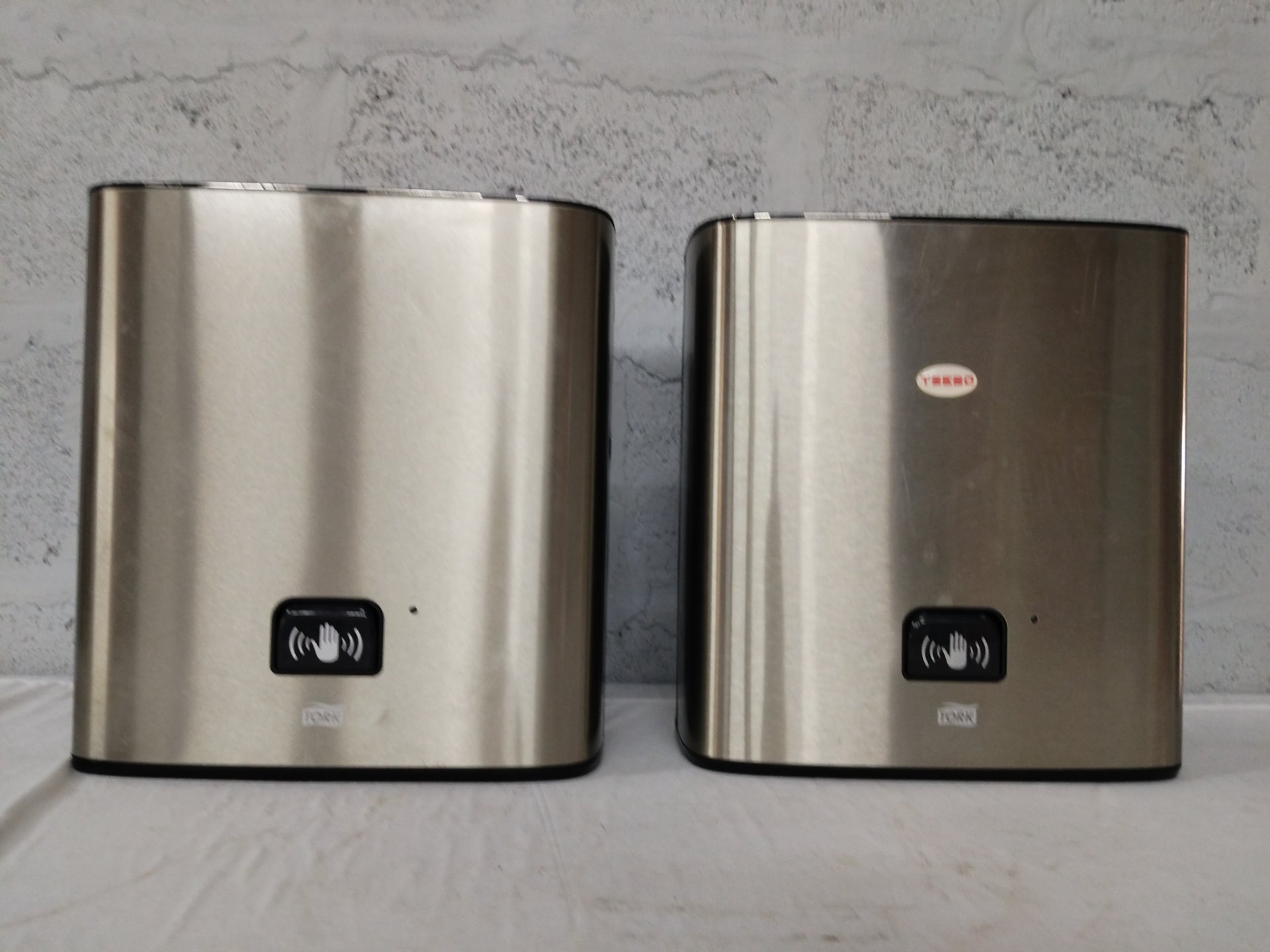 Lot of 2 Tork stainless automatic paper towel dispensers — battery-powered, working with faults (broken towel holder)