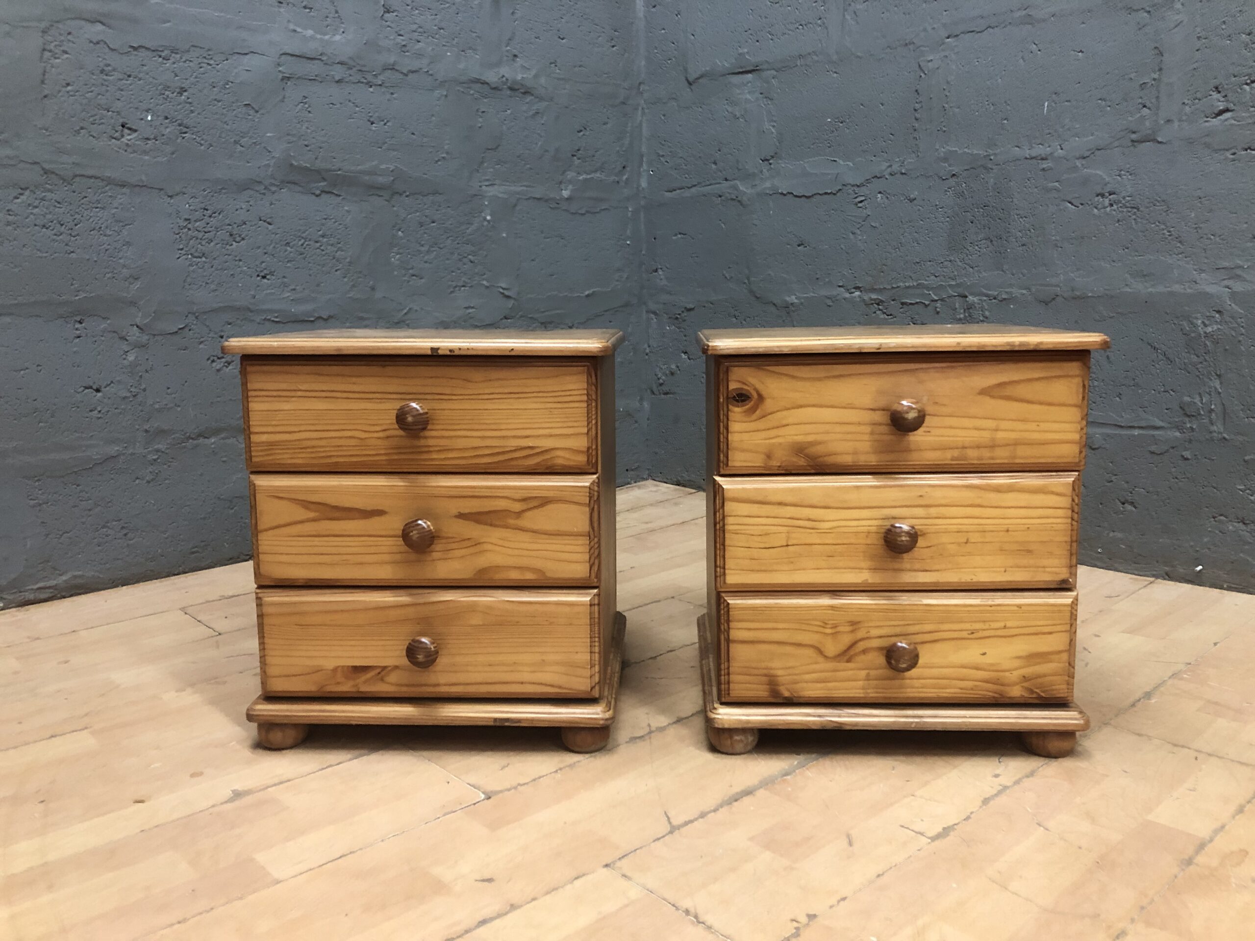Pair of small three-drawer bedside cabinets, light brown honey tone