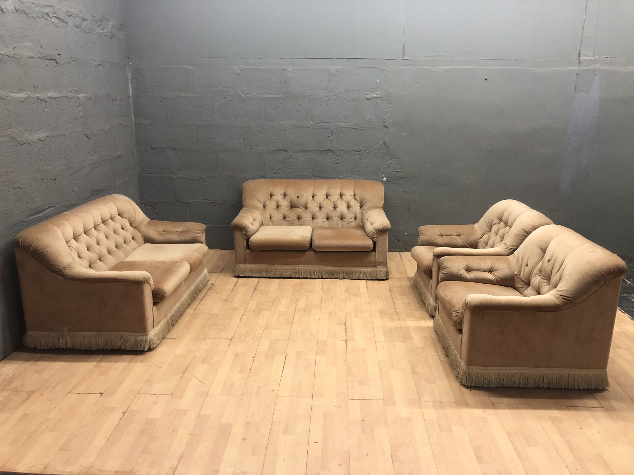 Four-piece tan/beige upholstered seating set (sofas + armchairs)