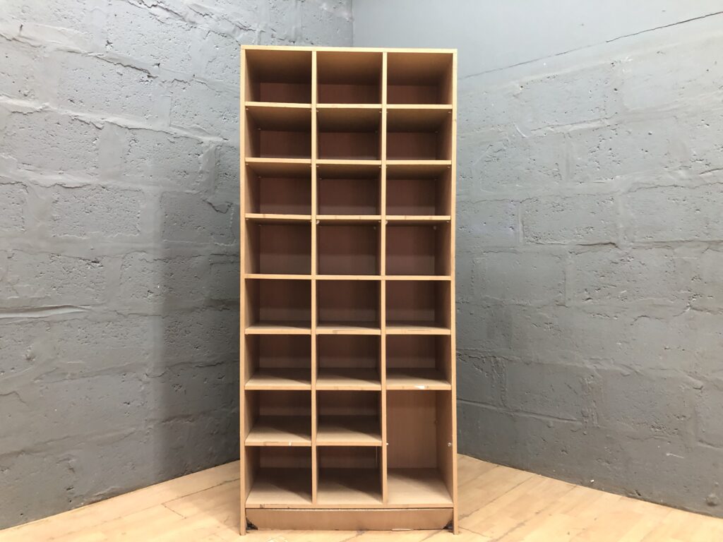 Multi-compartment cubby shelving unit — light wood-tone finish, freestanding