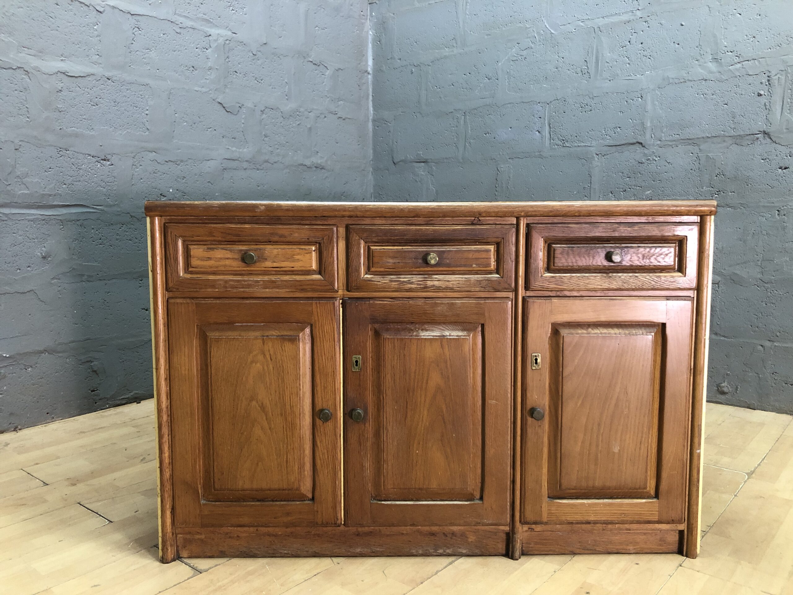 Wood-tone Sideboard / Cabinet — 3 Drawers, 3 Doors, Noticeable Top Stain
