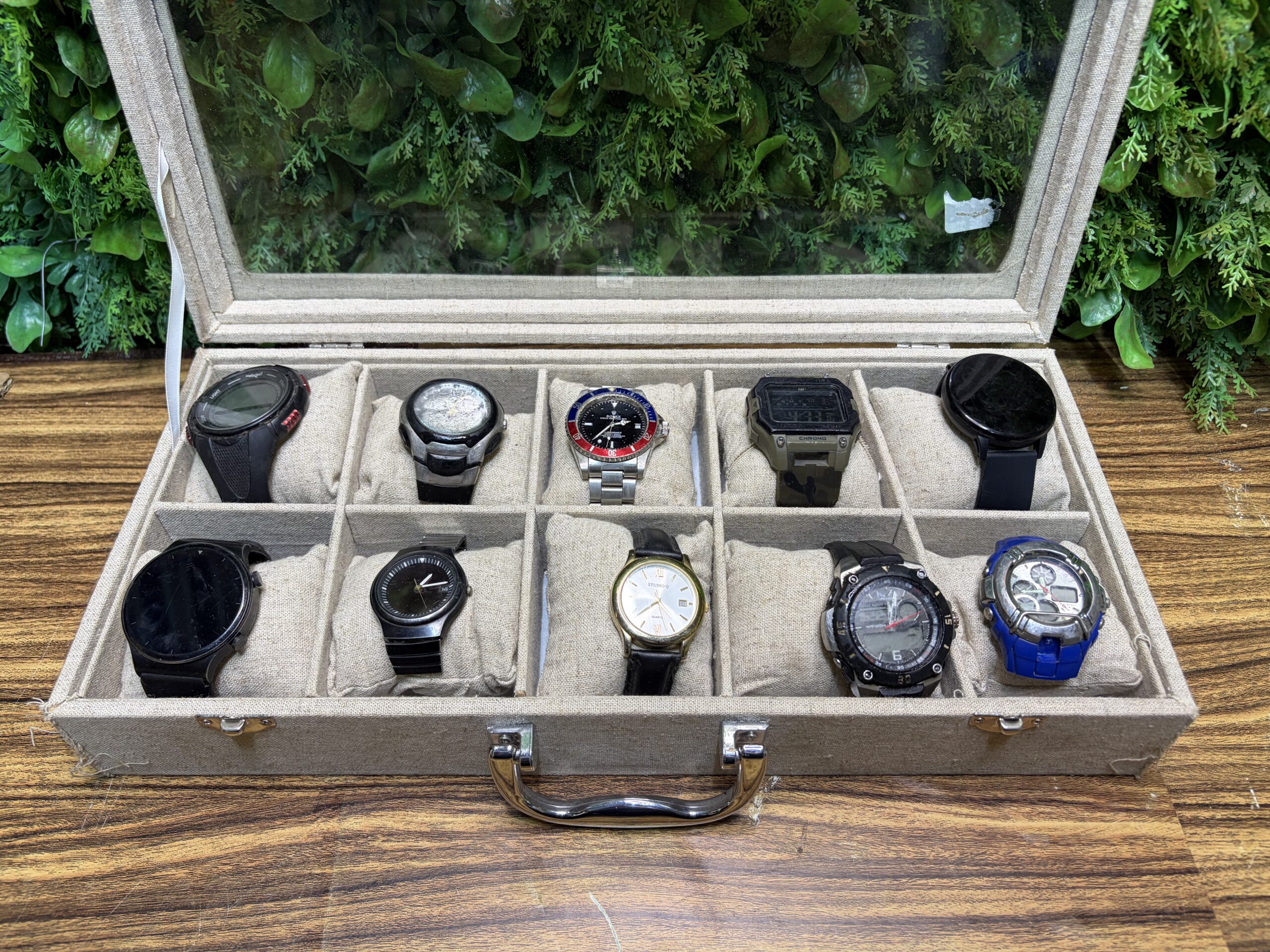 Lot of 10 Wristwatches in Glass-Top Display Case — Mixed Condition