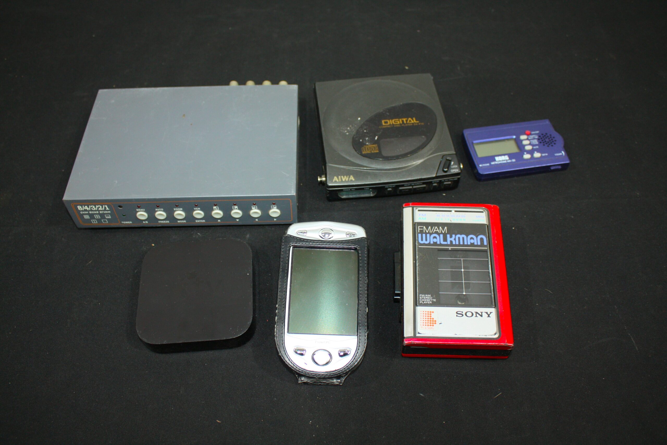 Mixed electronic lot — Walkman, Discman, PDA, Apple TV-style box, KORG tuner, video unit (6pcs)