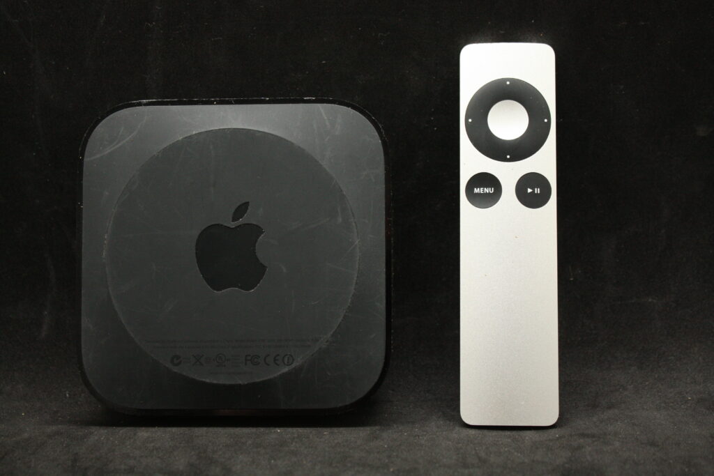 Apple TV set-top box with aluminum remote — sold as-is, no refund