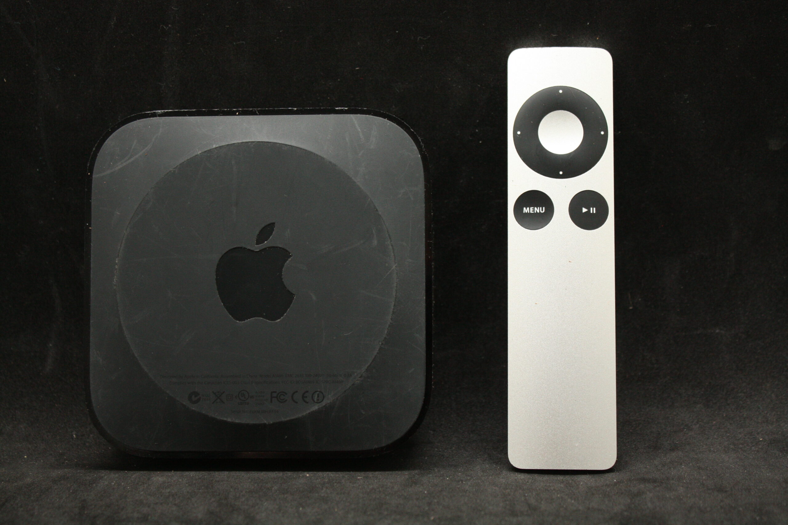 Apple TV set-top box with aluminum remote — sold as-is, no refund