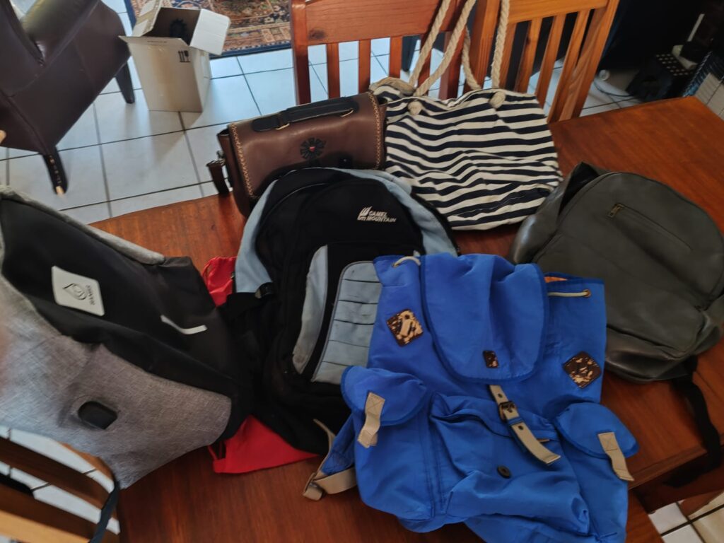 Mixed lot of 6 used bags — backpacks, tote and satchel, grey & black