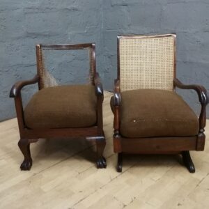 Pair of wooden armchairs with woven cane backs and brown cushions