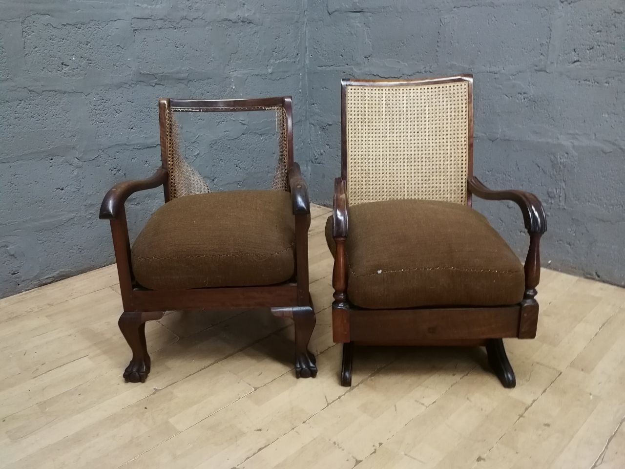 Pair of wooden armchairs with woven cane backs and brown cushions
