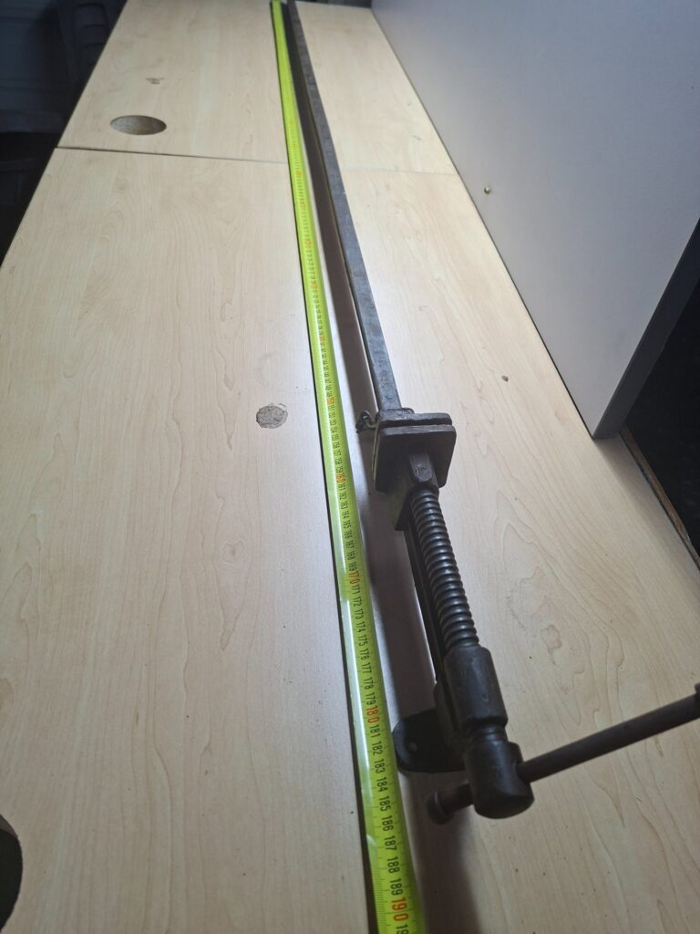 Long cast-iron WODEN sash / bar clamp — ~190cm, heavy surface rust, cracked sliding jaw, screw operates