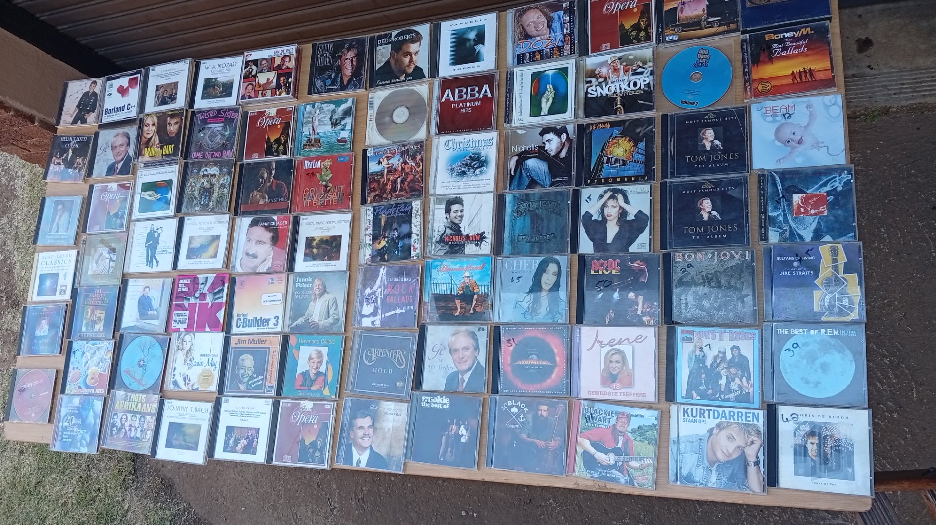 Bulk lot ~250 used audio CDs — mixed artists (ABBA, Bon Jovi, Elton John etc), many jewel cases, some cracked / marked, untested